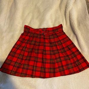 Dark red plaid skirt. Comes to about upper thigh.